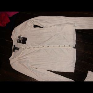 A black & a white shirt with pearls